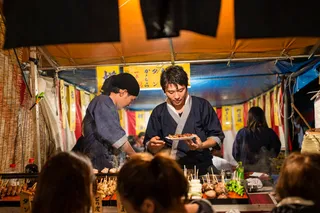 a group of people at a food stand