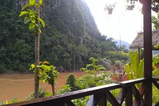 The private balcony affords spectacular views down the Nam Ou River