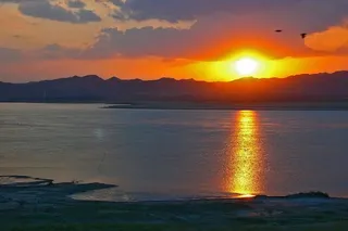 Watch the sun go down from the riverbank